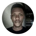 Godwin indoors in a dark room, looking straight down the lens